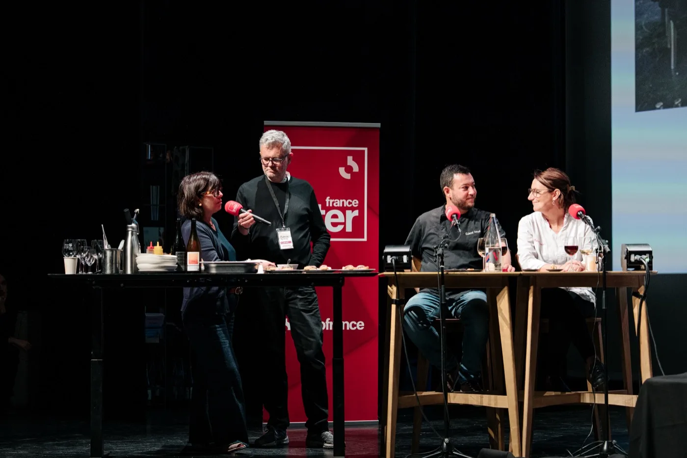 Le plateau de l'émission « On va déguster » installé sur la scène du festival, banderole France Inter en fond
